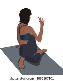 The girl is engaged in yoga sits in a pose on the mat and meditates