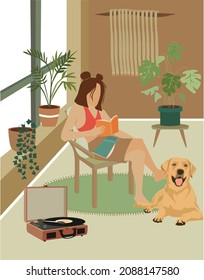 The girl is enjoying book with a shiba inu dog in the cozy house. Youth lifestyle, house and animals concept
