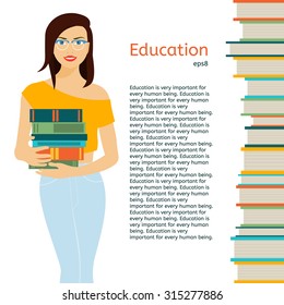 Girl in eyeglasses standing on a white background and holds a stack of books.