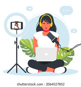girl gamer sits at a laptop playing a video game. Cybersport. Professional esports tournament event, player at computer with live video game. woman records herself on camera as she works at the laptop