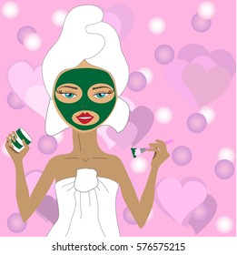 girl with green mudpack on her face in a white towel