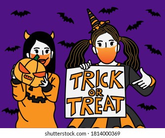 A girl in Halloween costume holding the pumpkin and a girl in witch costume holding the trick or treat label. wearing mask during pandemic outbreak of Coronavirus or Covid-19. New Normal lifestyle.
