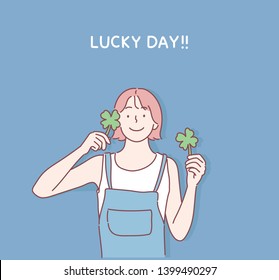 Girl hands with clover flowers. Hand drawn style vector design illustrations.