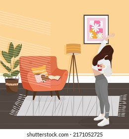 the girl has woken up and is drinking coffee in a cozy room with a dog