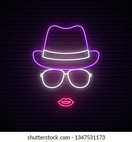 Girl in hat and sunglasses neon silhouette. Bright signboard. 