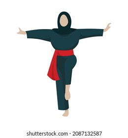 A girl with hijab demonstrate a move of silat, a martial arts from Indonesia. A female athlete lift one of her leg and spread her arms.