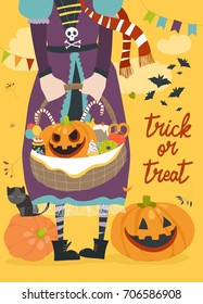 Girl holding basket with pumpkin and sweets