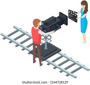 Girl holding movie clapper on camera. Filming starts, clap before new scene. Process of filming in pavilion. Man working with movie creation equipment. Cameraman shoots film on professional camera