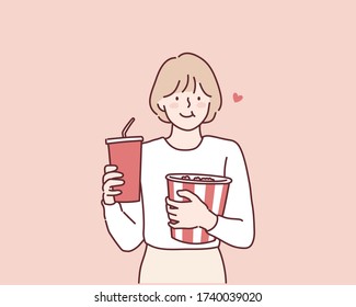 Niña sosteniendo una taza de plástico de cola o un cubo de soda de palomitas. Ilustraciones de diseño vectorial de estilo dibujado a mano.