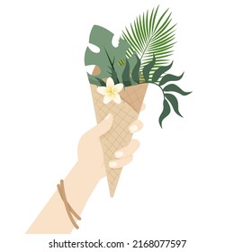 The girl holds in her hand a waffle ice cream cone with tropical leaves in it. 