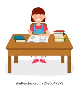 Girl kid doing homework or funny pupil studying lessons. Student sitting at table desk with books and writing in book.