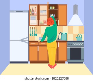 Girl in the kitchen. The girl washes the dishes and puts them in the closet on the shelf. Back view. Kitchen interior with furniture and kitchen appliances