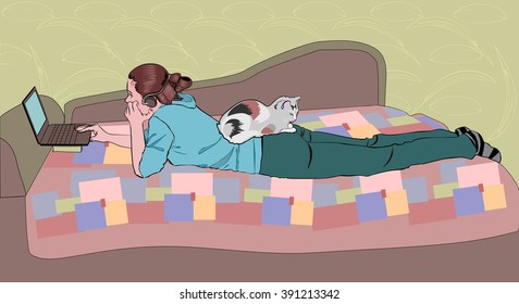 Girl with a laptop and a cat at home on the couch.