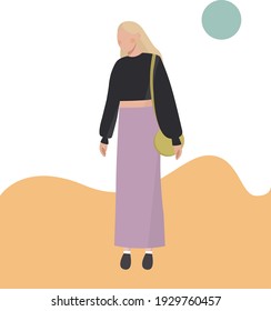 Girl in a long skirt with a bag on her shoulder