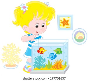 Girl looking at aquarium fishes