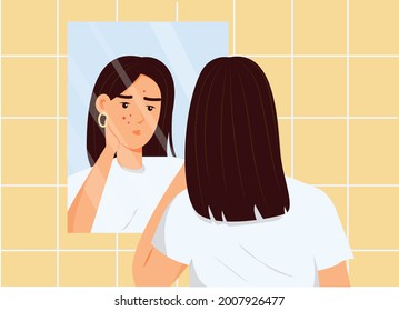 Girl looking in a bathroom mirror. Problem face skin with acne