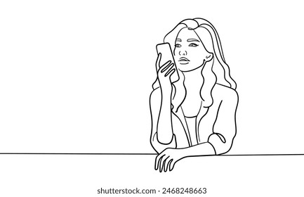 Girl looks on the phone continuous line art drawing isolated on white background. Vector illustration