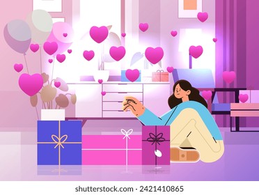 girl in love opening gift boxes in living room with pink air balloons in heart shape happy valentines day celebration concept