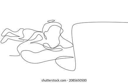 girl lying on the floor looking at the laptop and watching a video. The person who attends the video lesson comfortably at home.