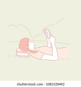 A girl lying on the grass reading a book. hand drawn style vector doodle design illustrations.