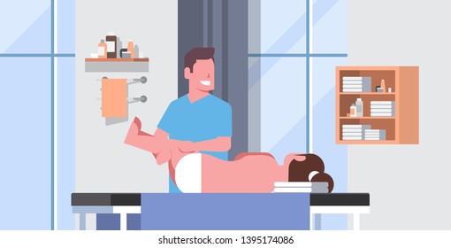 girl lying on massage table professional masseur therapist doing healing treatment massaging patient treating legs manual physical therapy concept medical clinic cabinet interior horizontal