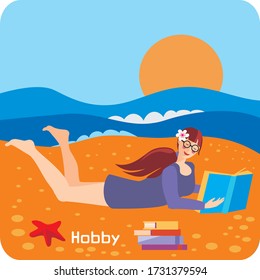 The girl is lying on the sand, on the beach near the sea and reading a book.