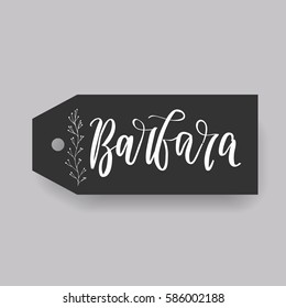 Girl name Barbara. Calligraphy lettering. Black badge decorated with botanical element and female name. Can be used as place card on wedding or anniversary.