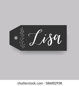 Girl name Lisa. Calligraphy lettering. Black badge decorated with botanical element and female name. Can be used as place card on wedding or anniversary.