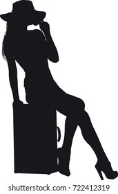 girl with an old suitcase in a short dress and hat resting while sitting