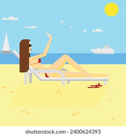 A girl on the beach sunbathing and blogging on the phone