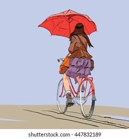 Girl on bike with umbrella autumn rain