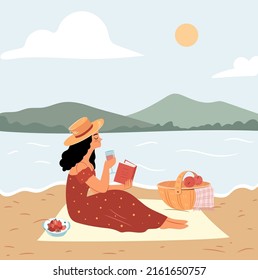 Girl on a picnic reading book. Summer beach picnic