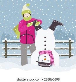 Girl on the snow with an upside down snowman