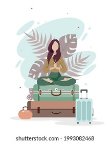 girl on suitcases meditates, waiting for travel, rest