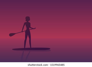 Girl on a sup board at sunset