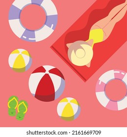 girl on towel with floats and balls, summer