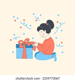 Girl opens a box with a gift