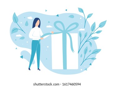 The girl opens a gift. Pulling a ribbon to untie a bow on a gift box