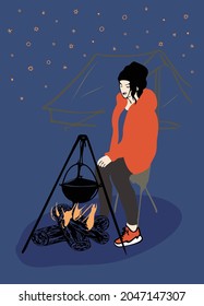  a girl in orange jacket, black sweatpants, orange sneakers sitting  under a blue sky cooking at a campsite, a triangular frame is hanging a black pot, 3 logs are burning in the fire, a tent behind.