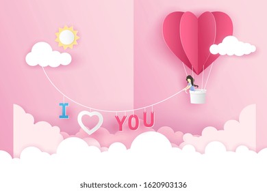 A girl in an origami pink balloon heart flying on the sky over the cloud in Valentine's day with text I Love You. Vector illustration art design in paper pop up or paper cut style. 