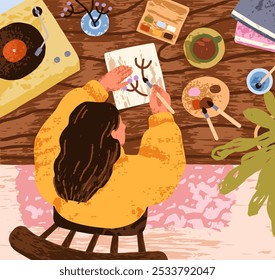 Girl painting, drawing at table, top view. Creative hobby, cozy home mood, vibe. Woman in sweater spending time, hygge leisure with art supplies, tea cup, vinyl record player. Flat vector illustration