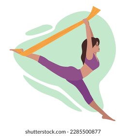 The girl performs twine hanging in an orange hammock. Yoga in a hammock, an exercise for stretching and flexibility.