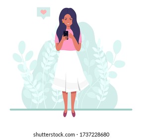 Girl with a phone in a flat style. Woman looking at the phone on the background of plants. Vector illustration.