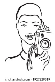 Girl photographer with camera.
Woman holds a camera and smiles.