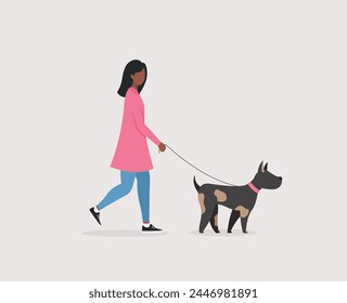 A girl in a pink coat walks with a dog on the street.