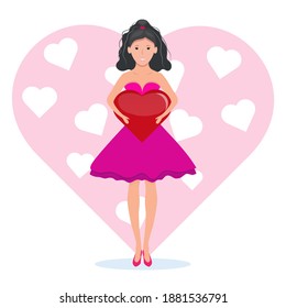 A girl in a pink dress holds a huge red heart in her hands