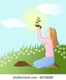 girl planting a seedling in nature