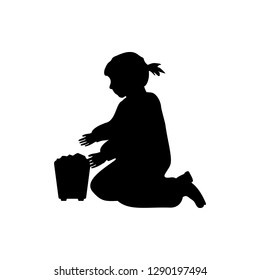 girl play in sand bucket silhouette