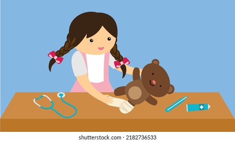 Girl playing doctor with teddy bear