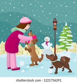 girl playing with a dog on a winter landscape